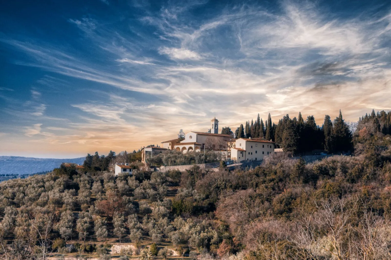Village of Panzano in Chianti at sunset with cypresses